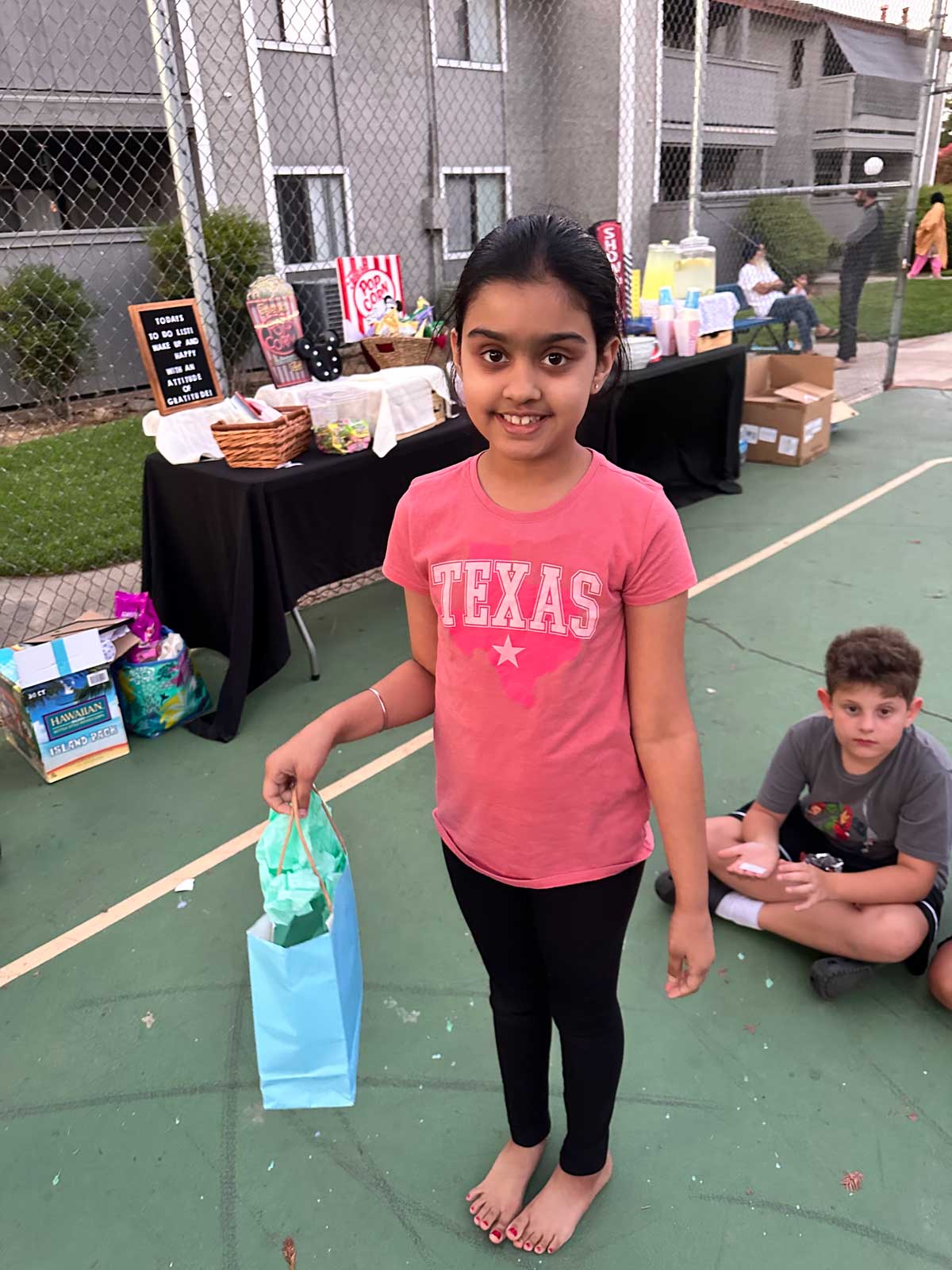 Girl holding a gift bag at a school event